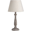 Table lamp with a beige shade and wooden base on a white background