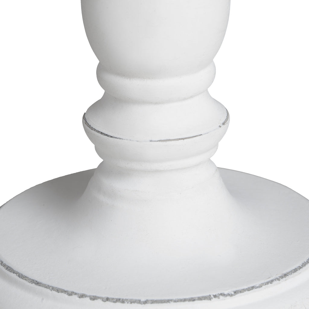 Close-up of a white decorative pedestal on a white background