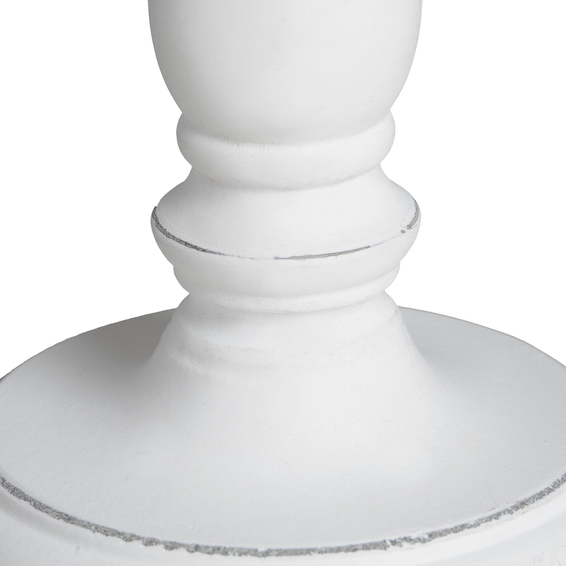 Close-up of a white decorative pedestal on a white background