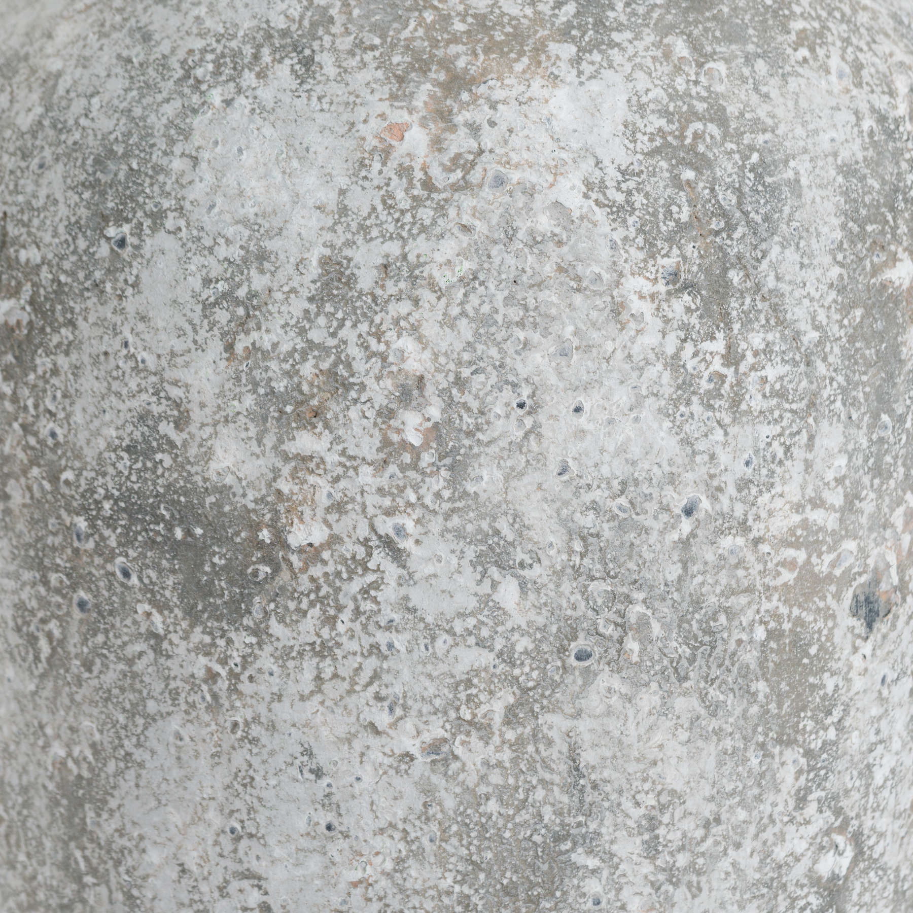 Close-up of a textured concrete surface with gray and brown tones.