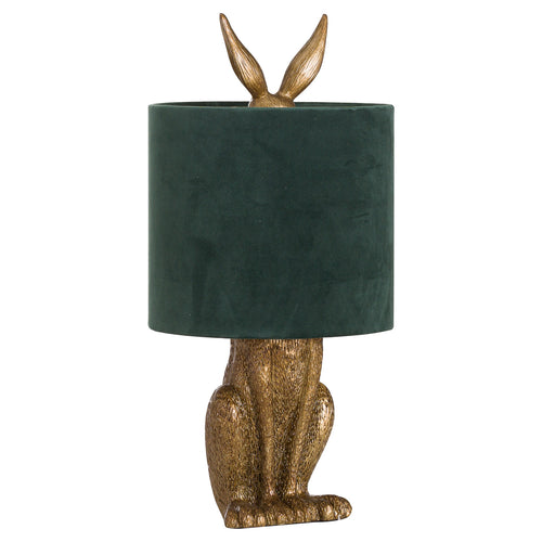 Decorative table lamp with gold rabbit body and green lampshade on a white background