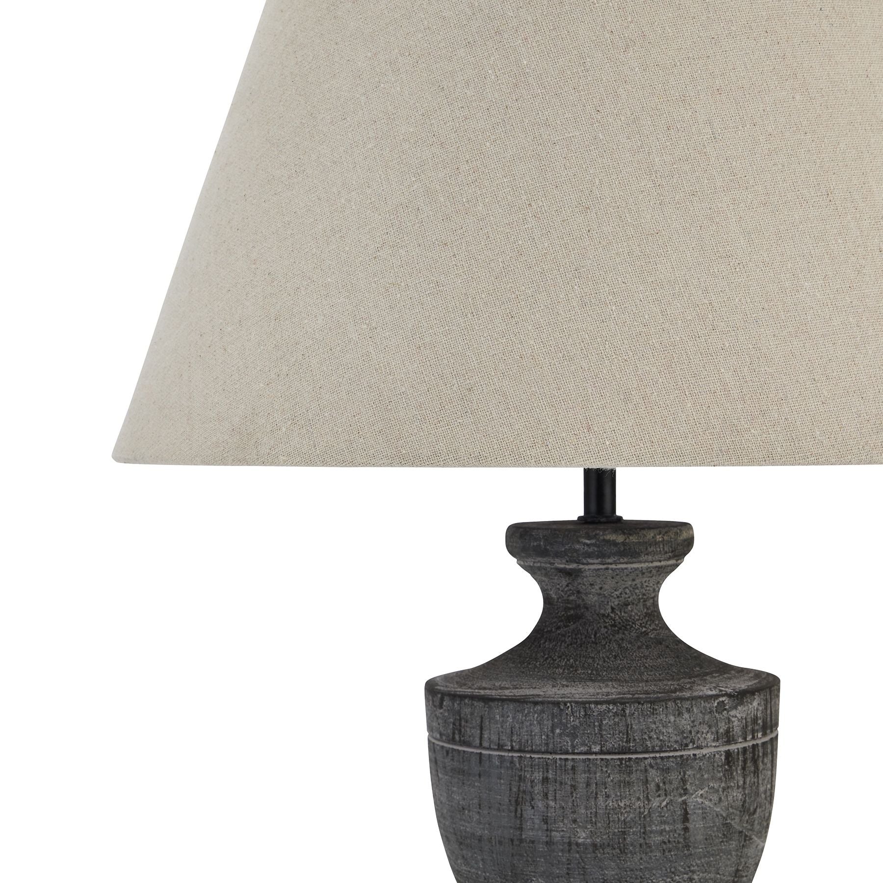 Table lamp with textured base and beige lampshade on a white background