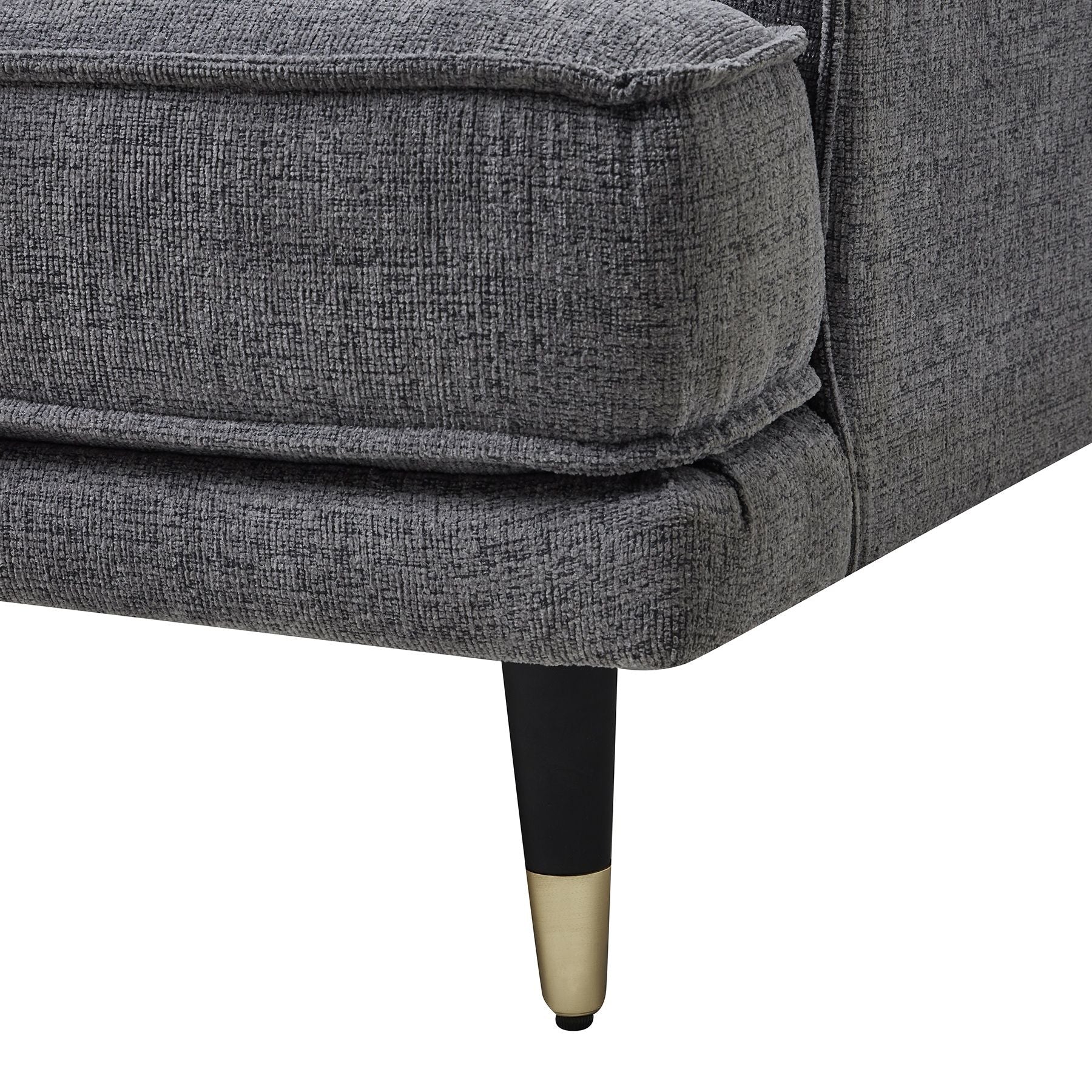 Gray upholstered chair with black and gold legs on a white background