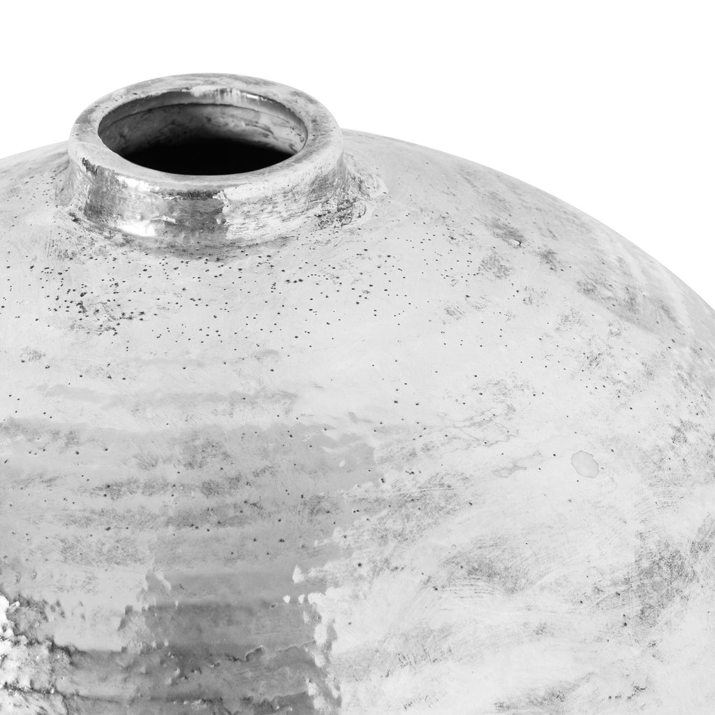 Close-up of a textured ceramic vase on a white background