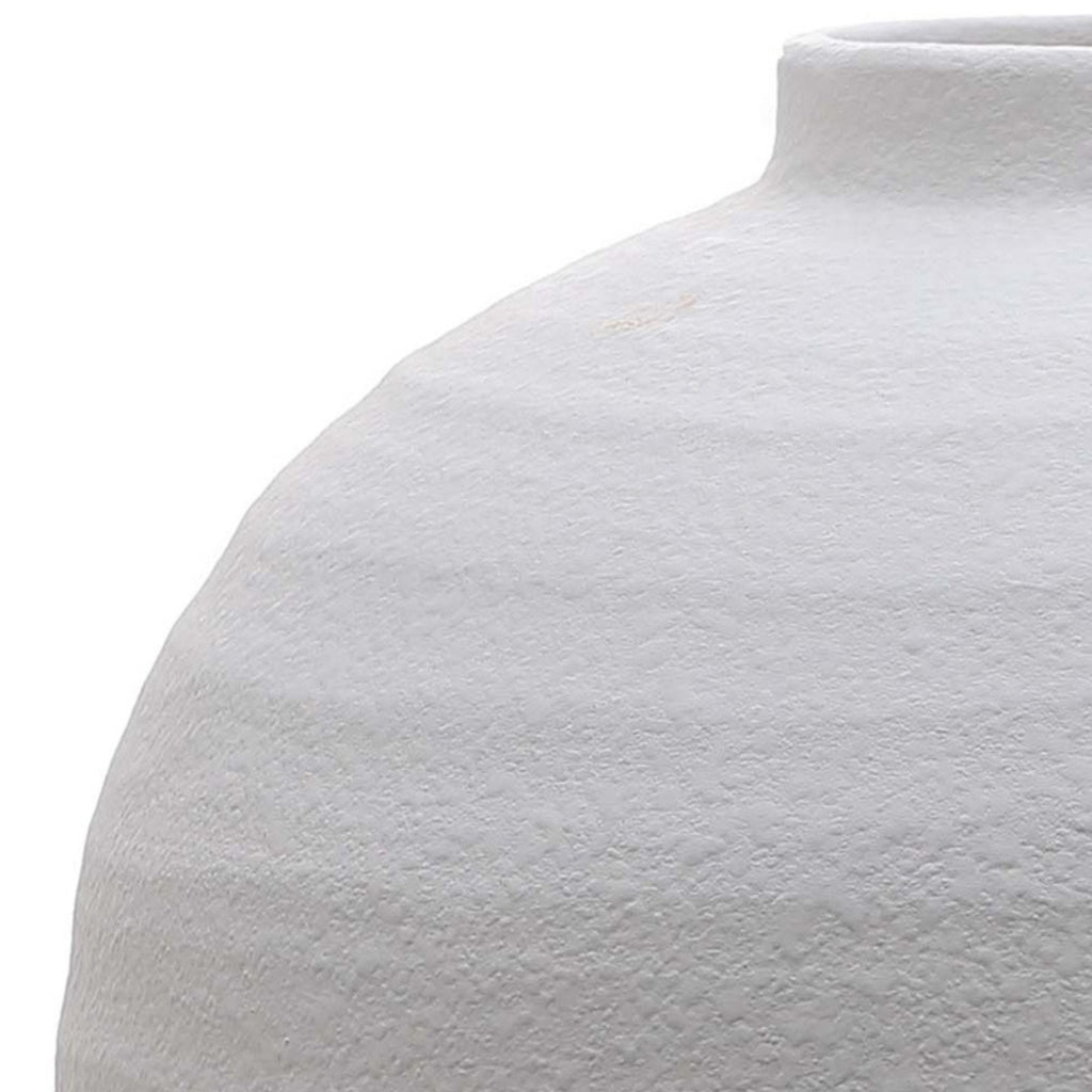 Close-up of a textured white ceramic vase on a white background