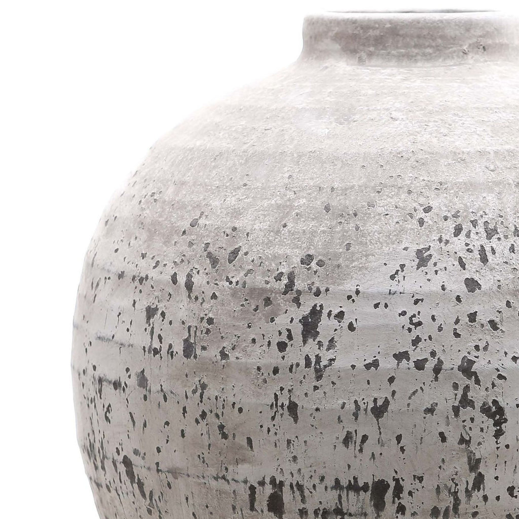 Close-up of a textured ceramic jar on a white background