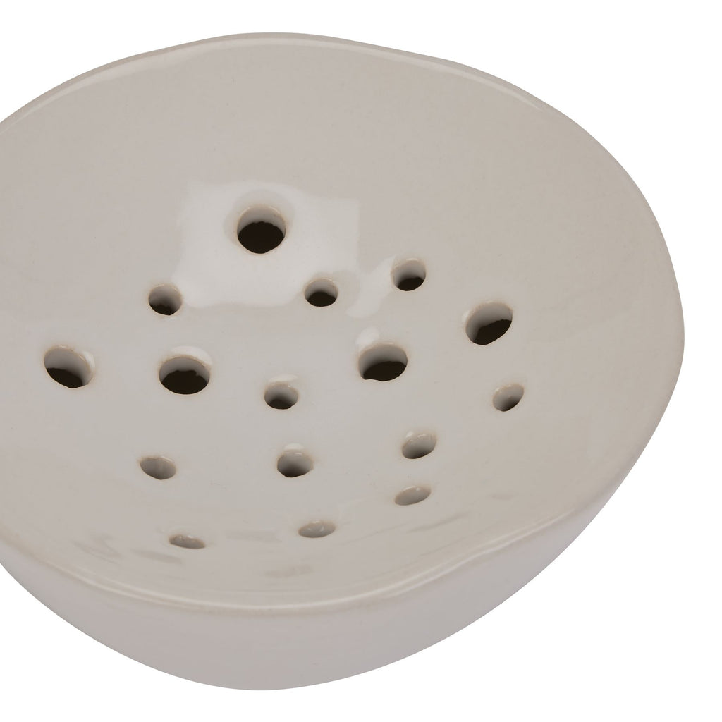 White sanding disc with multiple holes on a white background
