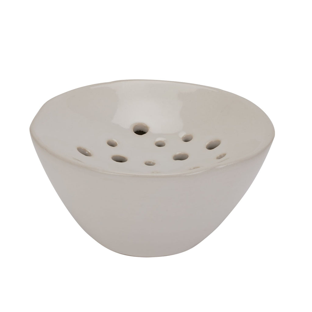 White ceramic bowl with holes on a white background