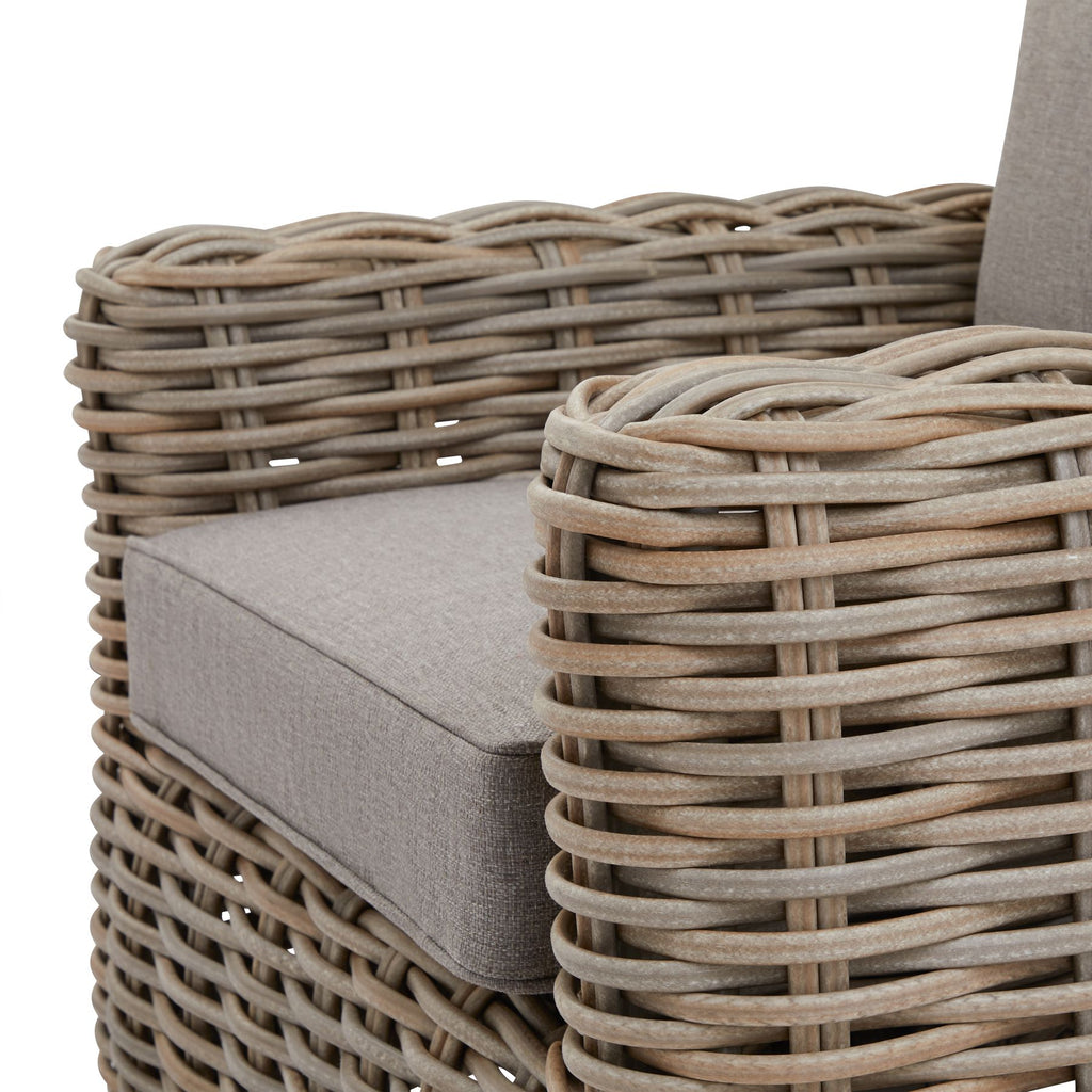 Close-up of a wicker chair with a cushion, focusing on the texture and design.
