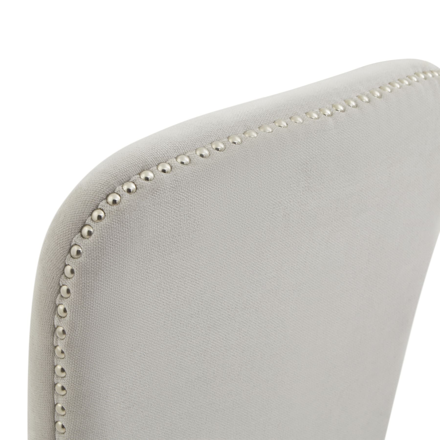 Gray upholstered chair with decorative nailhead trim on a white background