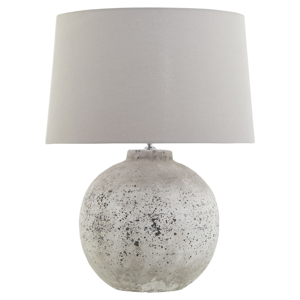 Table lamp with a textured concrete base and a gray fabric shade on a white background