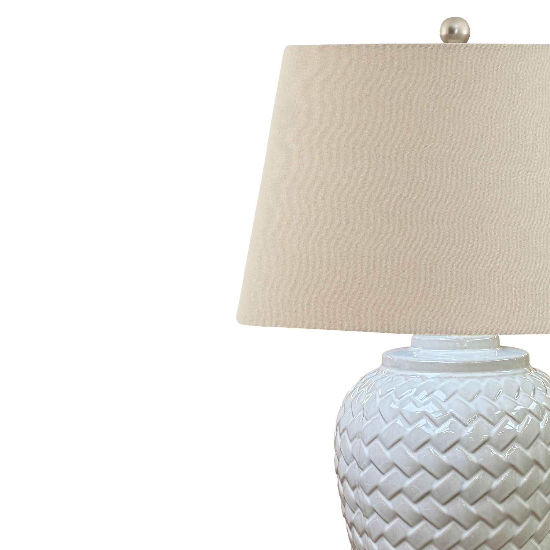Table lamp with woven design base and beige lampshade on a white background