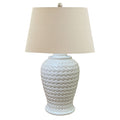 White textured table lamp with a beige lampshade on a white background