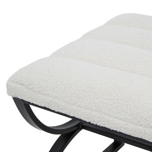 Close-up of a textured white cushion on a black metal frame