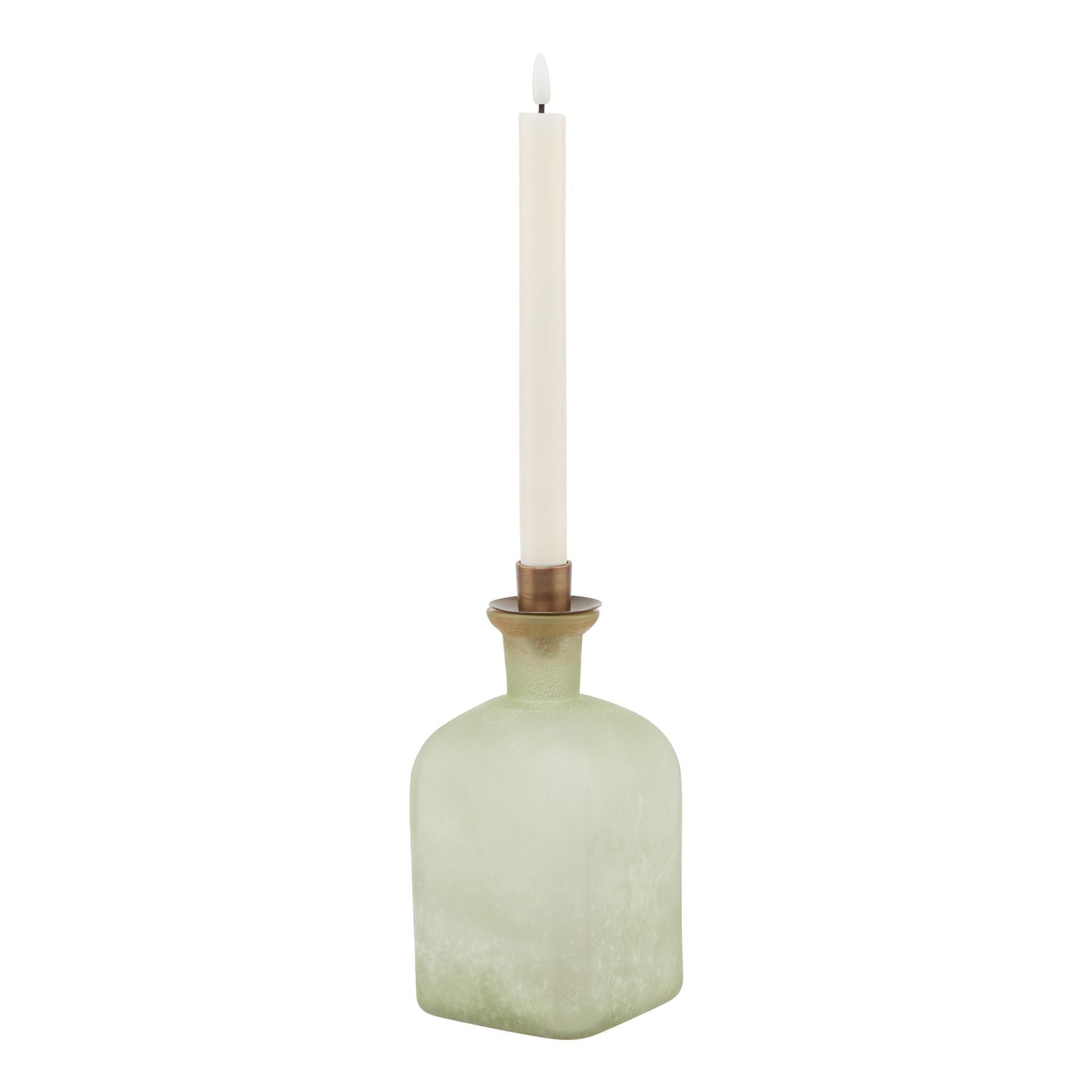 Green textured bottle with a white candle inside on a white background