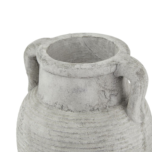 Decorative stone vase with handles on a white background