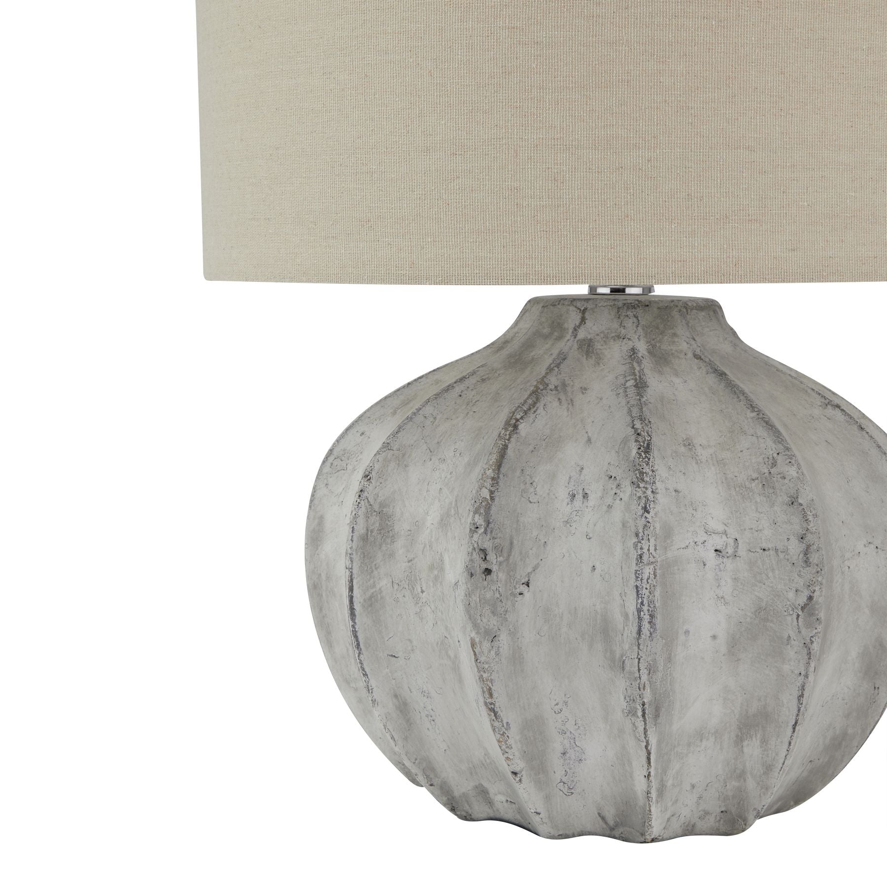 Table lamp with textured gray base and beige lampshade on a white background