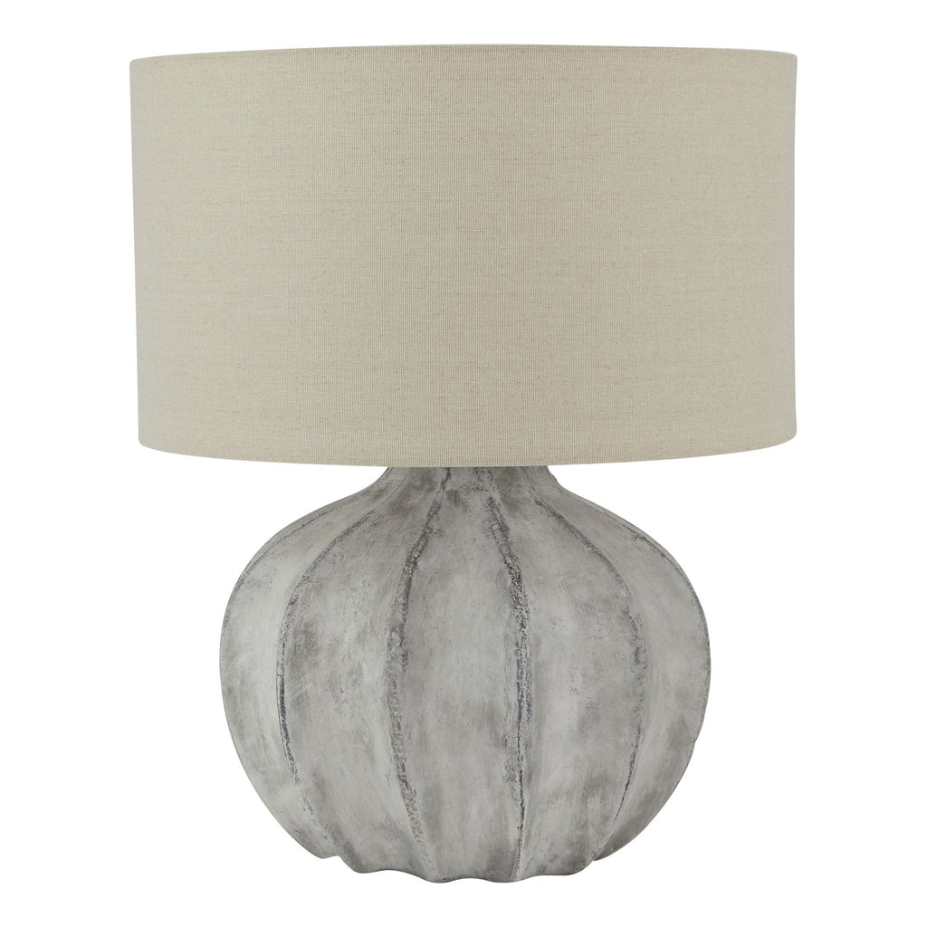 Table lamp with textured gray base and beige lampshade on a white background
