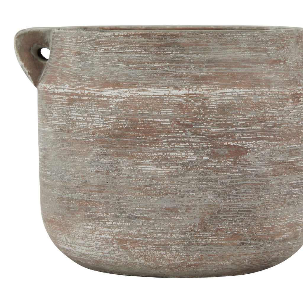 Textured ceramic planter with a handle on a white background