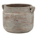 Ceramic planter with a textured surface on a white background