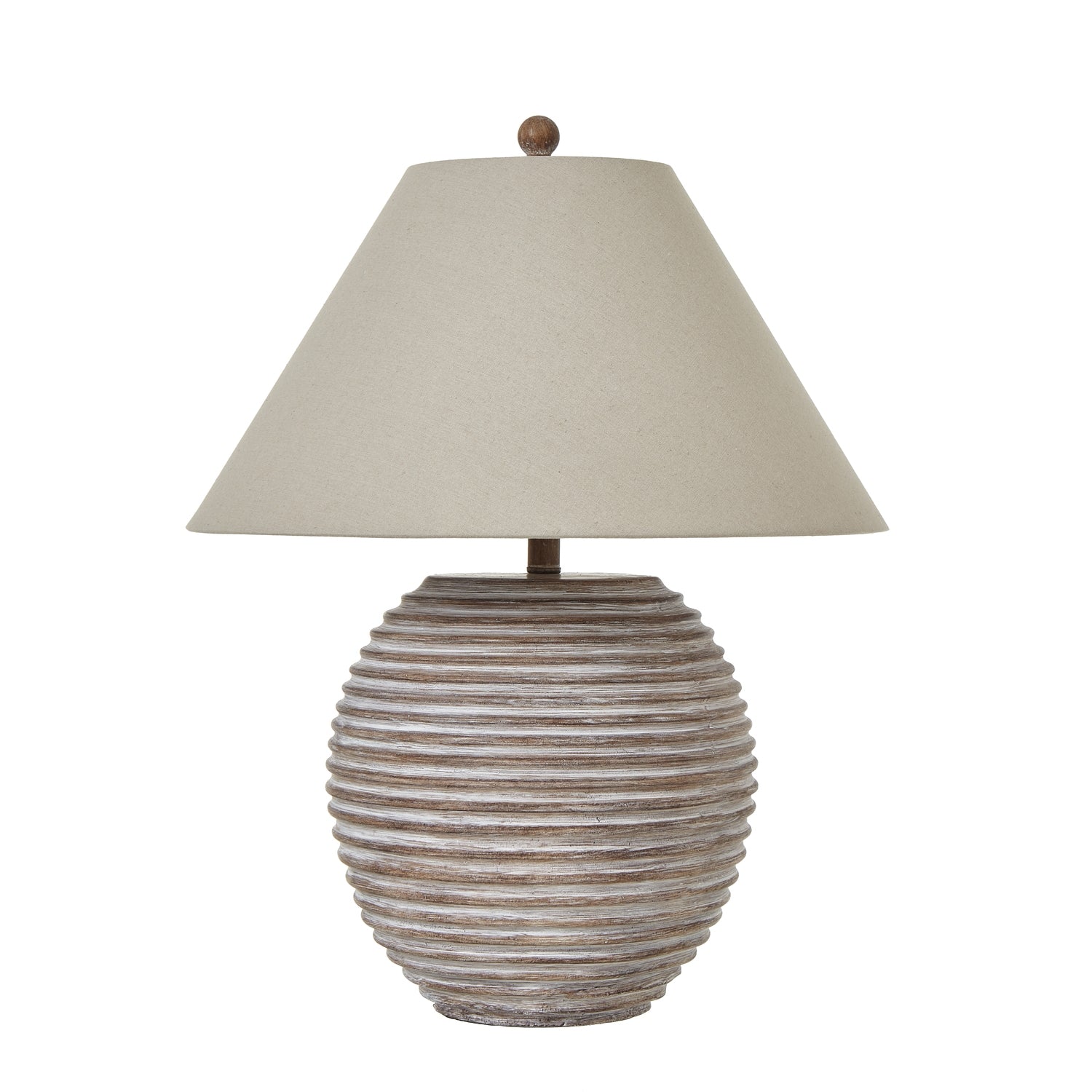 Table lamp with ribbed ceramic base and beige shade on a white background