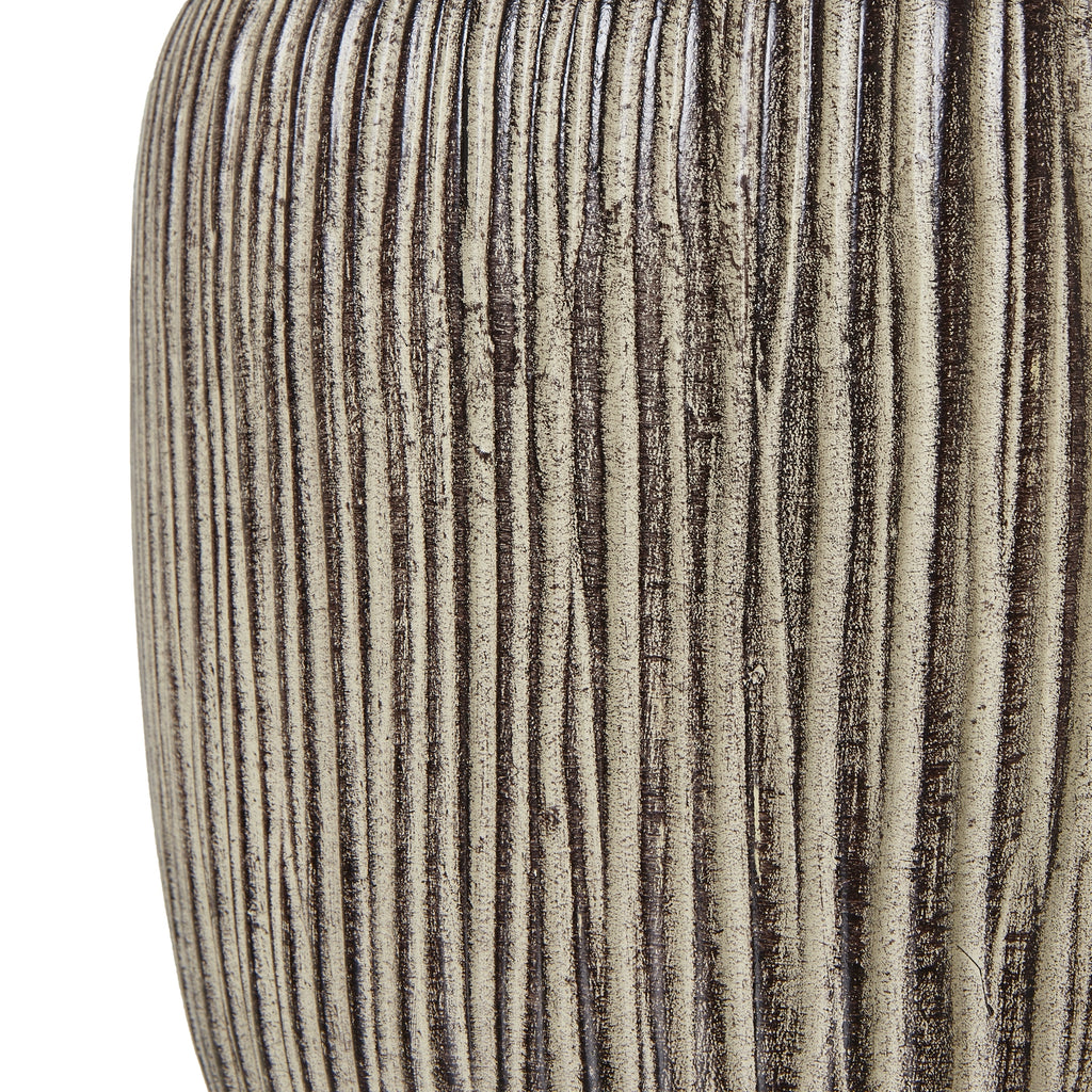Textured vase with vertical ribbing on a white background