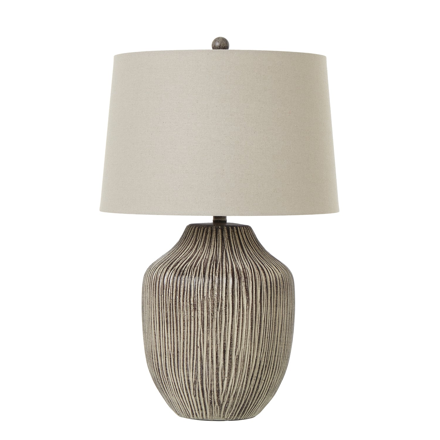 Table lamp with textured base and beige shade on a white background