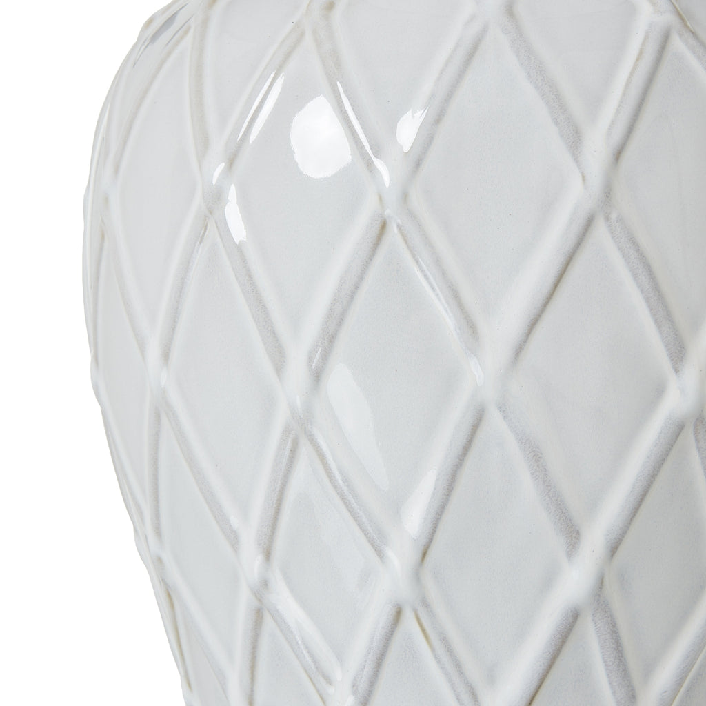 White ceramic vase with geometric lattice pattern on a white background