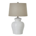 White textured table lamp with a beige lampshade on a white background