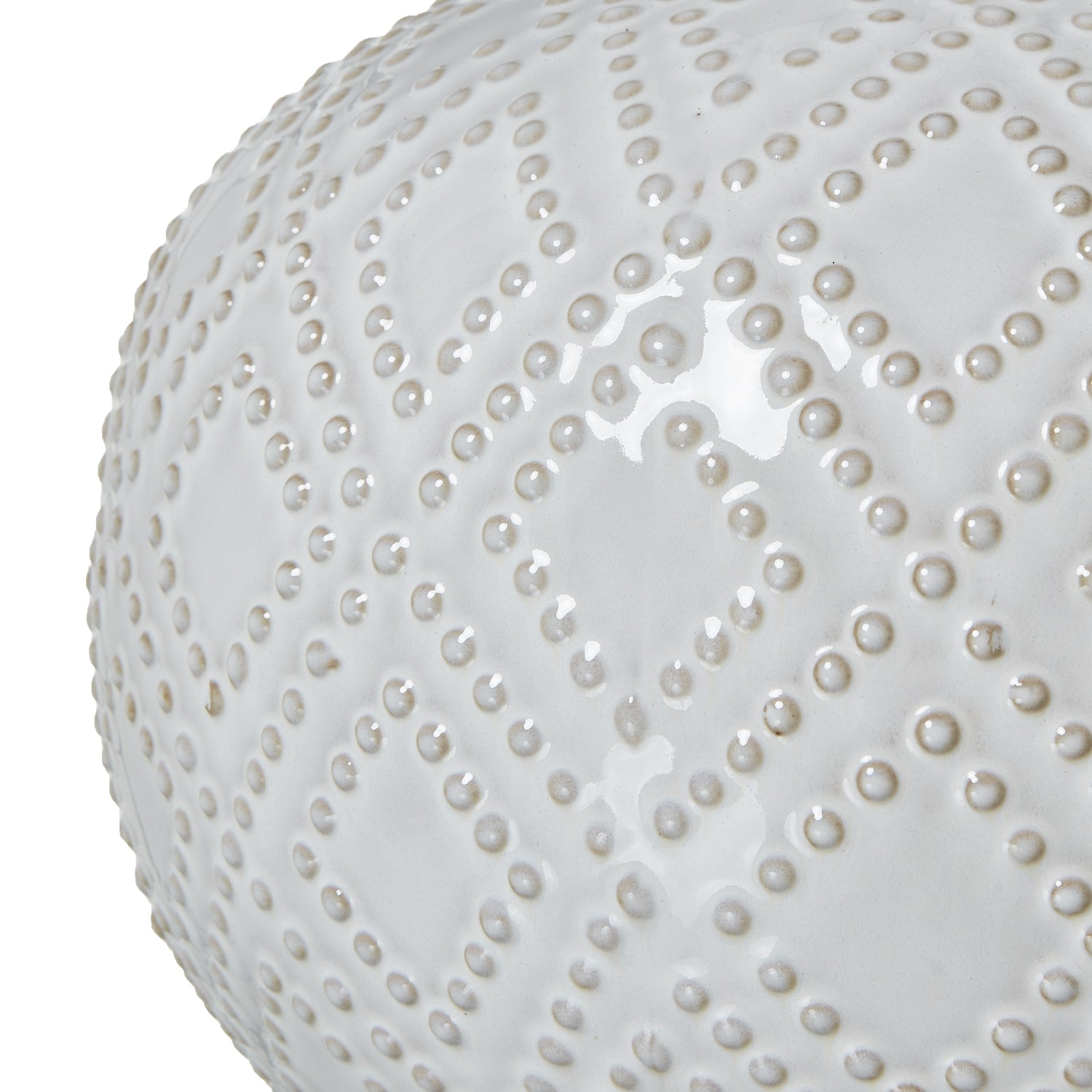 Close-up of a white spherical object with a textured surface on a white background