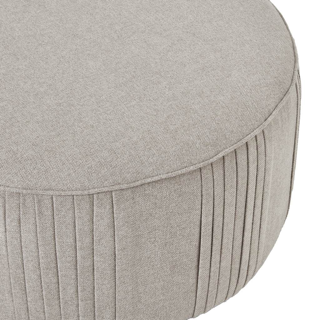 Round gray ottoman with pleated design on a white background