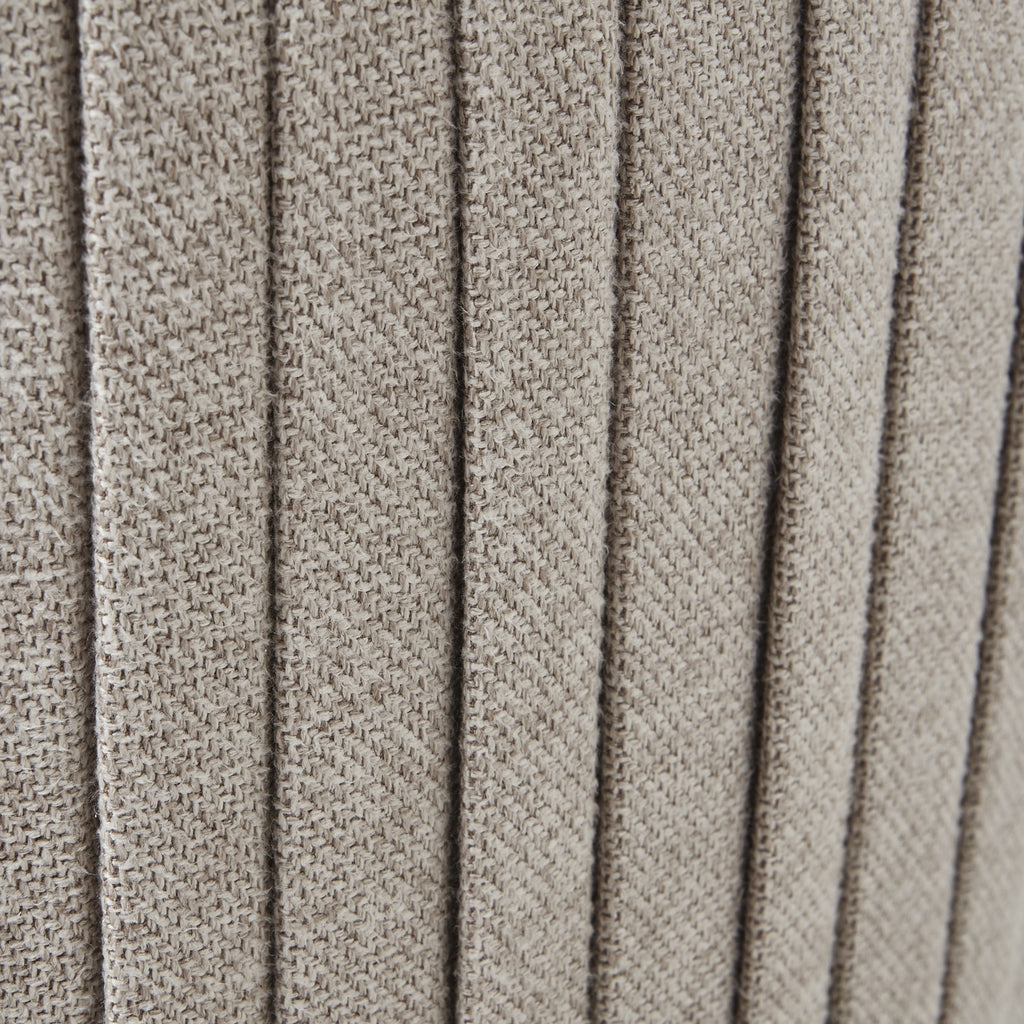 Close-up of textured beige fabric with a ribbed pattern