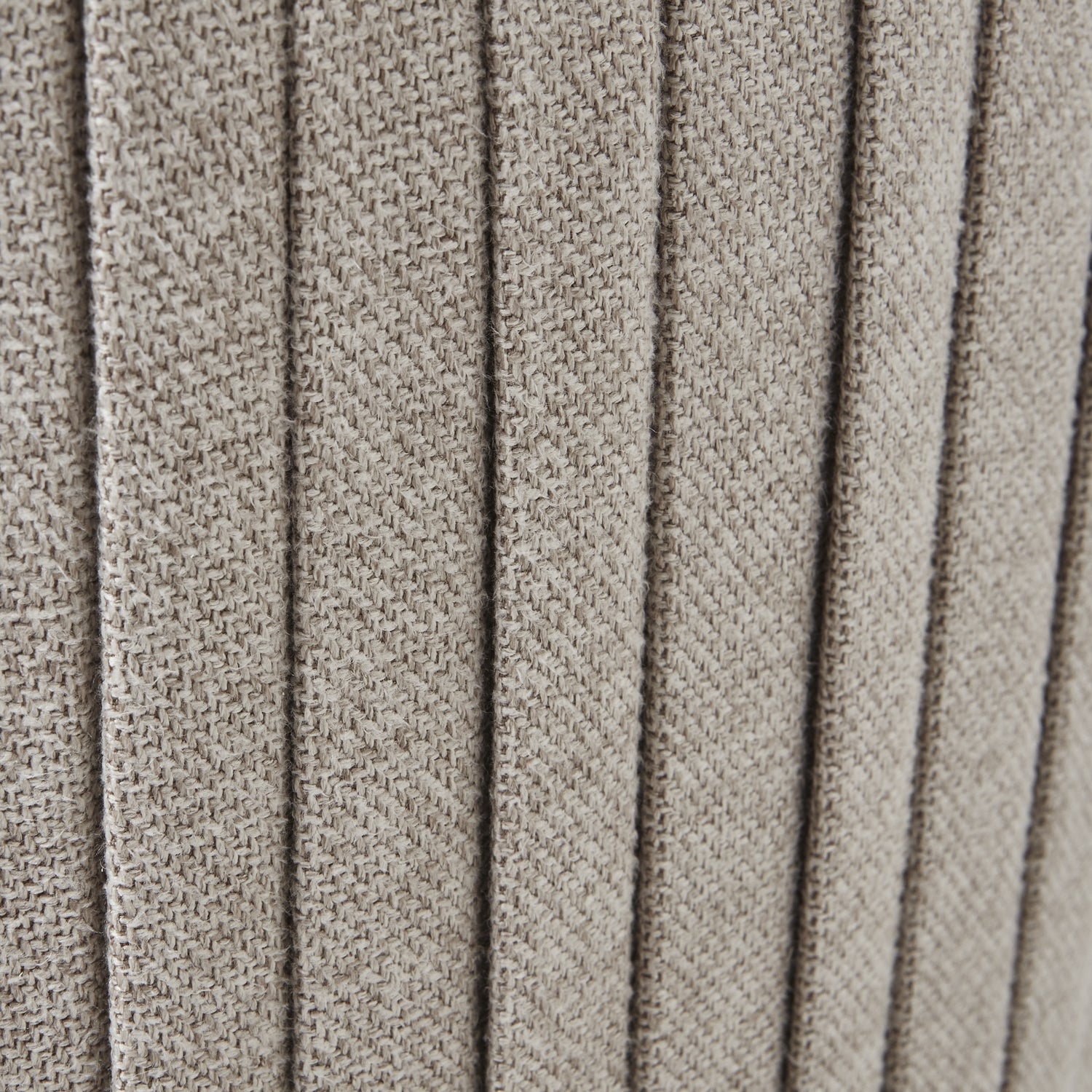 Close-up of textured beige fabric with a ribbed pattern