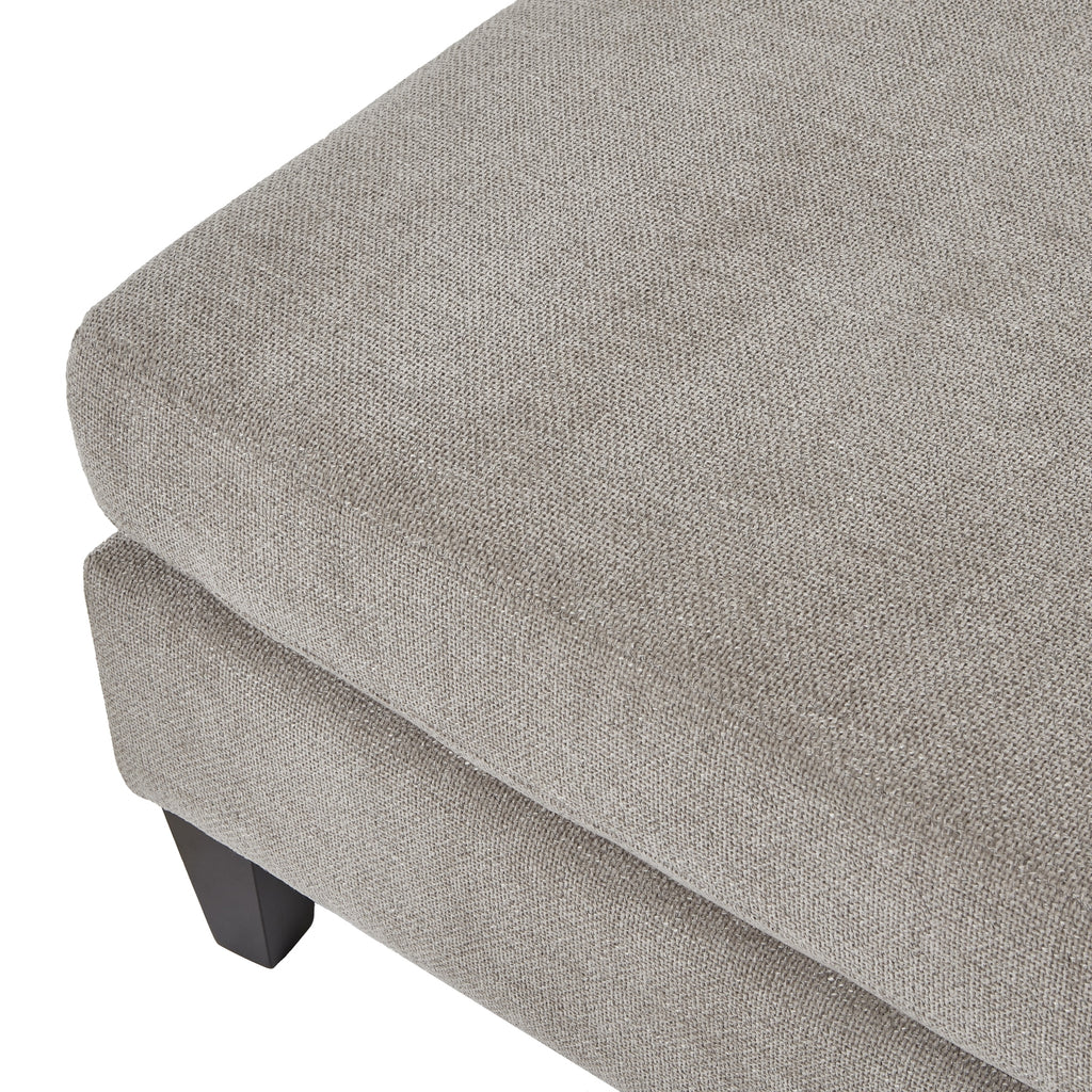 Gray upholstered ottoman with a textured surface on a white background