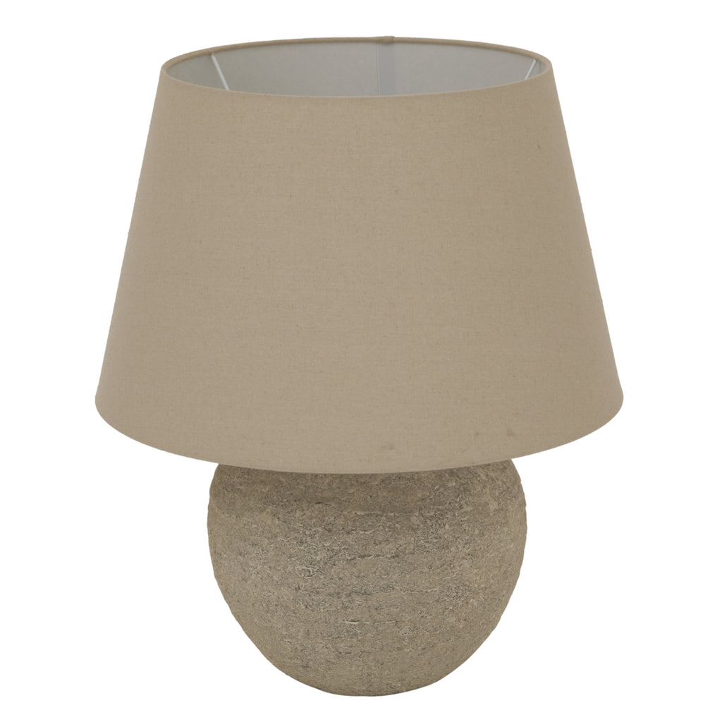 Beige table lamp with a round base on a white background