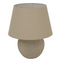 Beige table lamp with a round base on a white background
