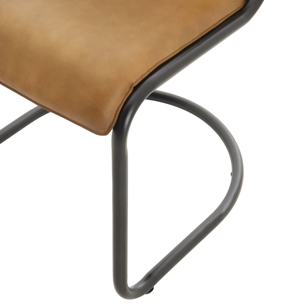 Close-up of a brown leather chair with black metal frame on a white background