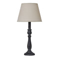 Table lamp with a beige shade and dark wooden base on a white background