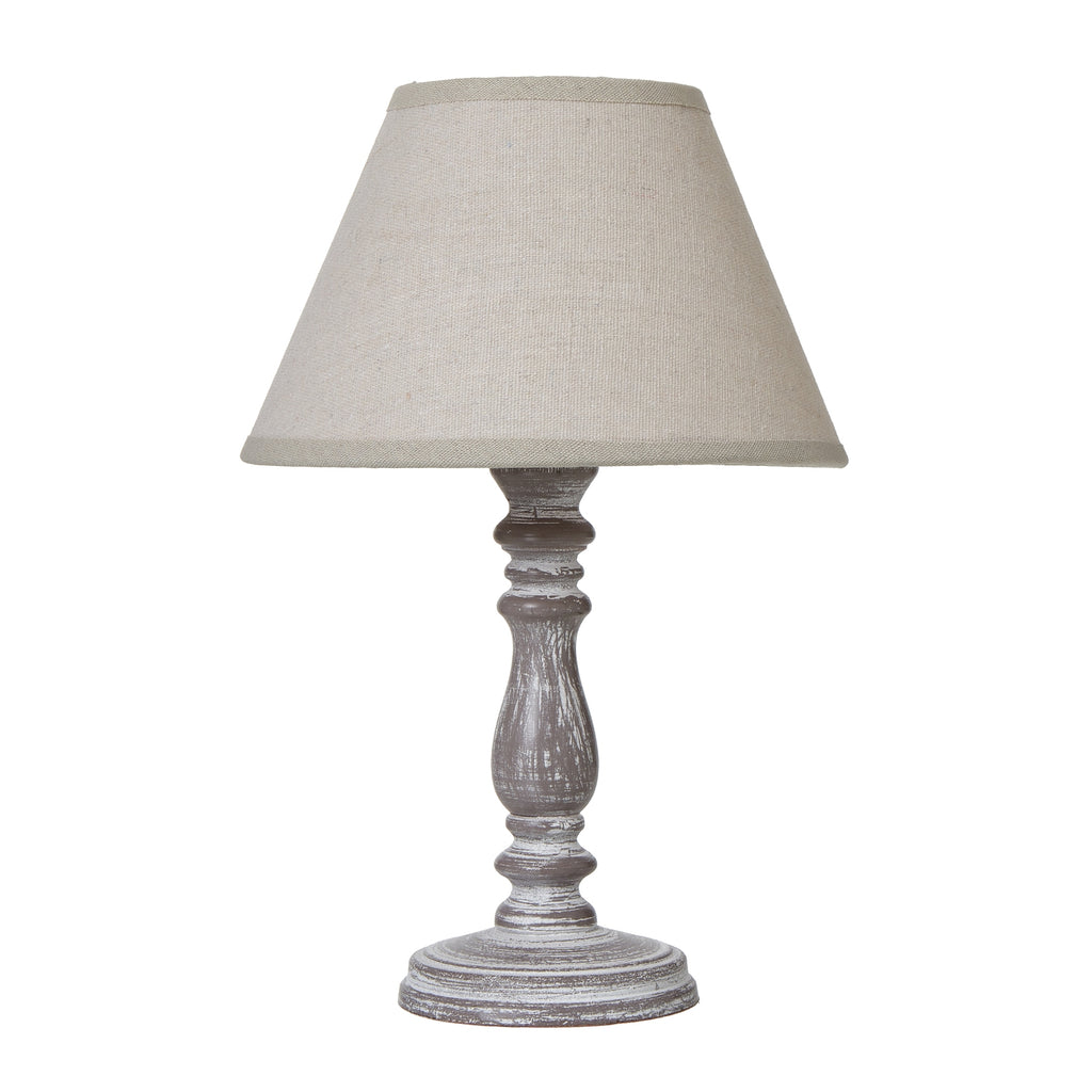 Table lamp with a beige shade and wooden base on a white background