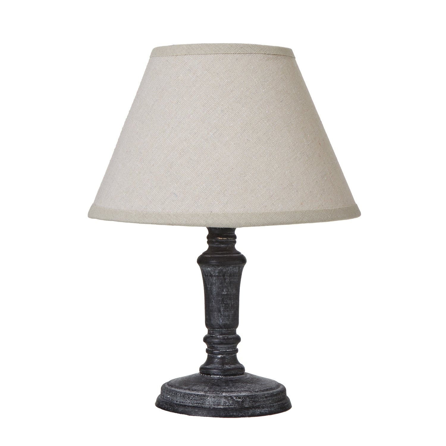 Table lamp with a beige shade and dark metal base on a white background
