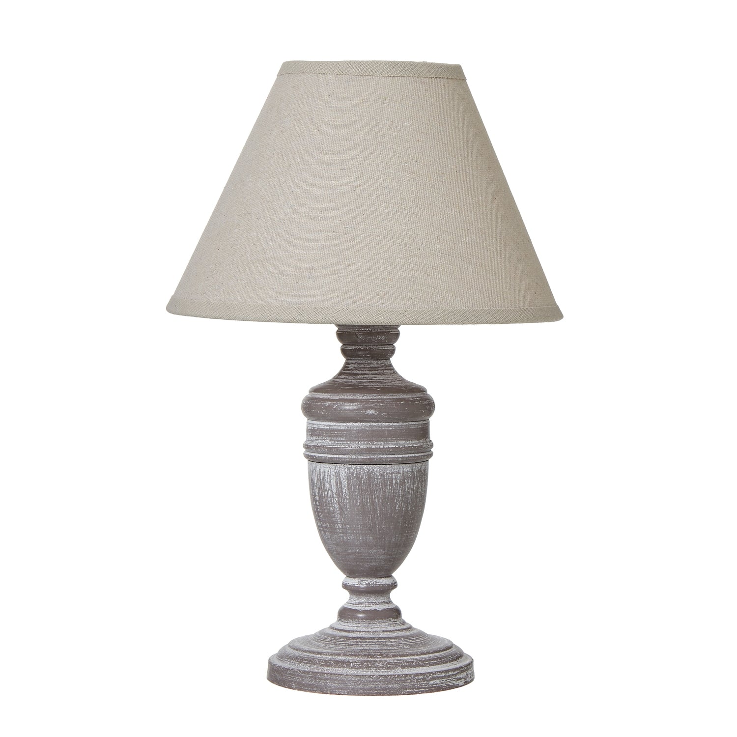 Table lamp with a textured base and beige shade on a white background
