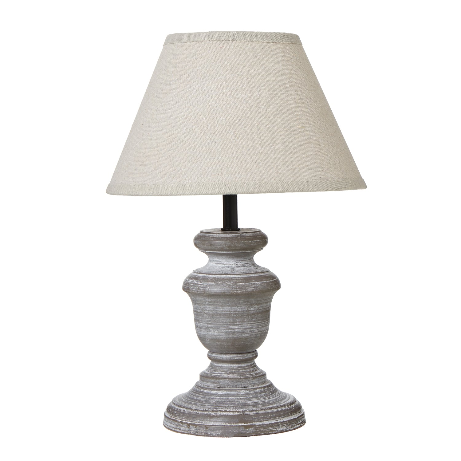 Table lamp with a textured base and beige shade on a white background