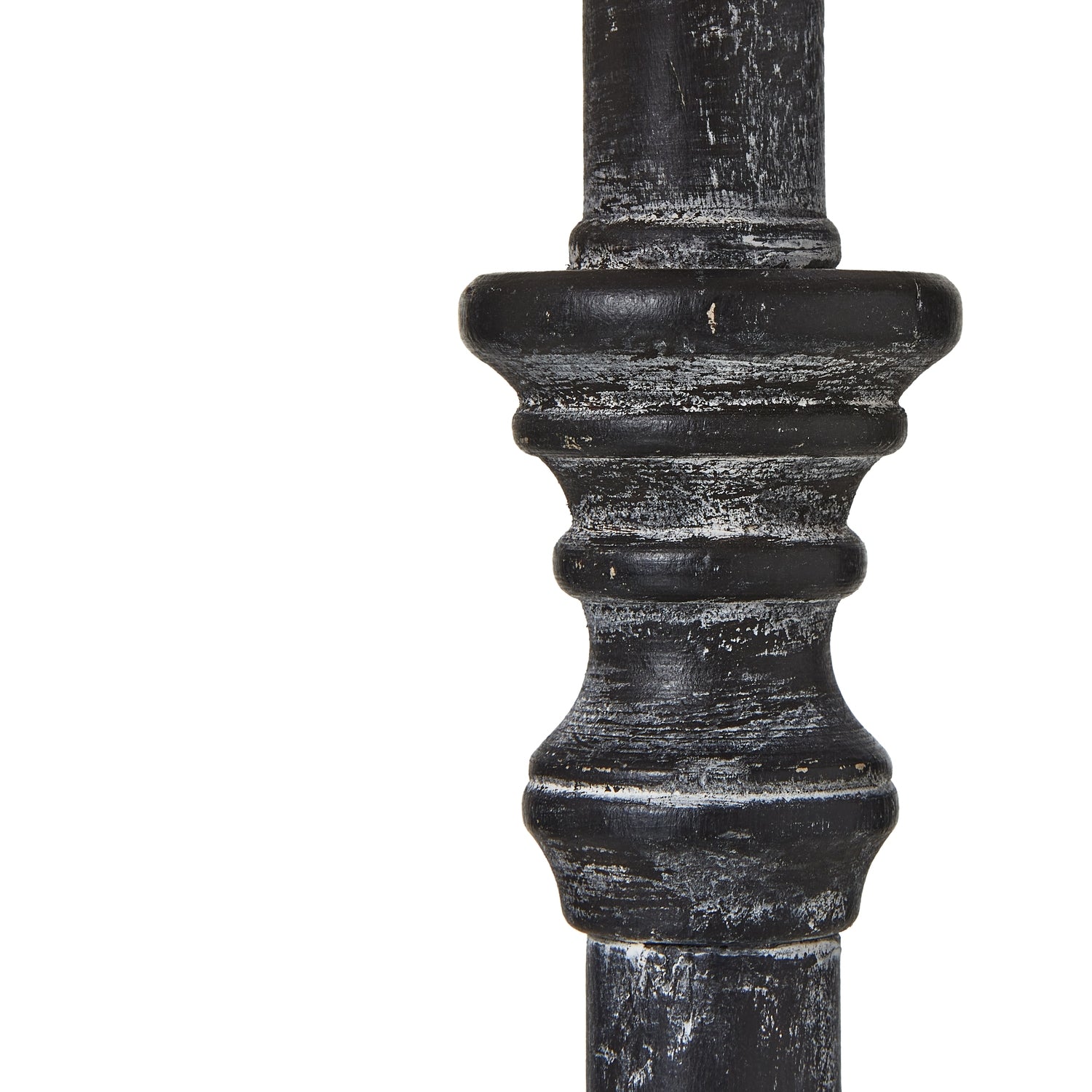 Close-up of a black metal pole with decorative top on a white background