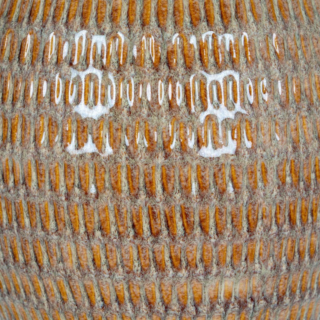 Close-up of a textured surface with a brand logo.