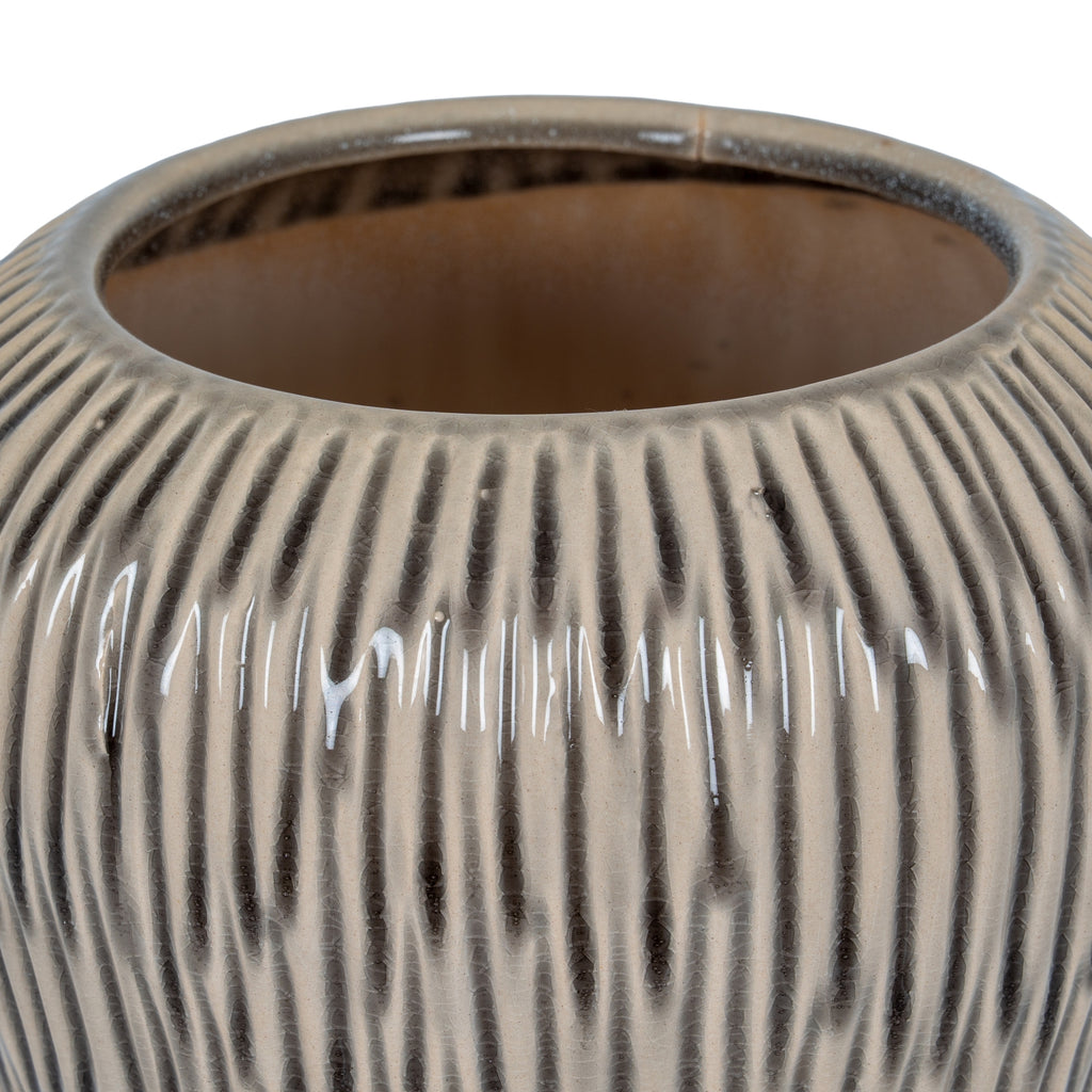 Close-up of a textured ceramic vase on a white background