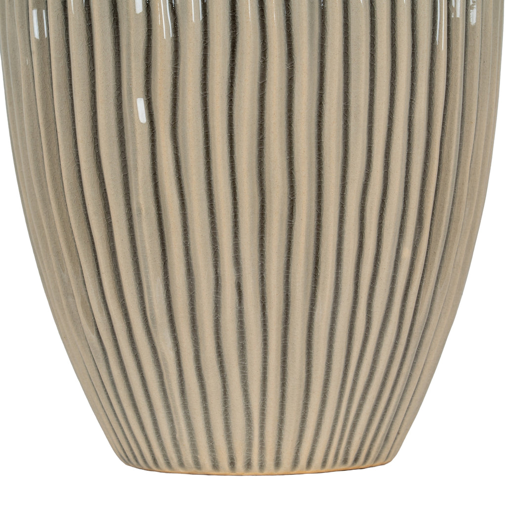Cylindrical ceramic vase with ribbed texture and black vertical stripes on a white background