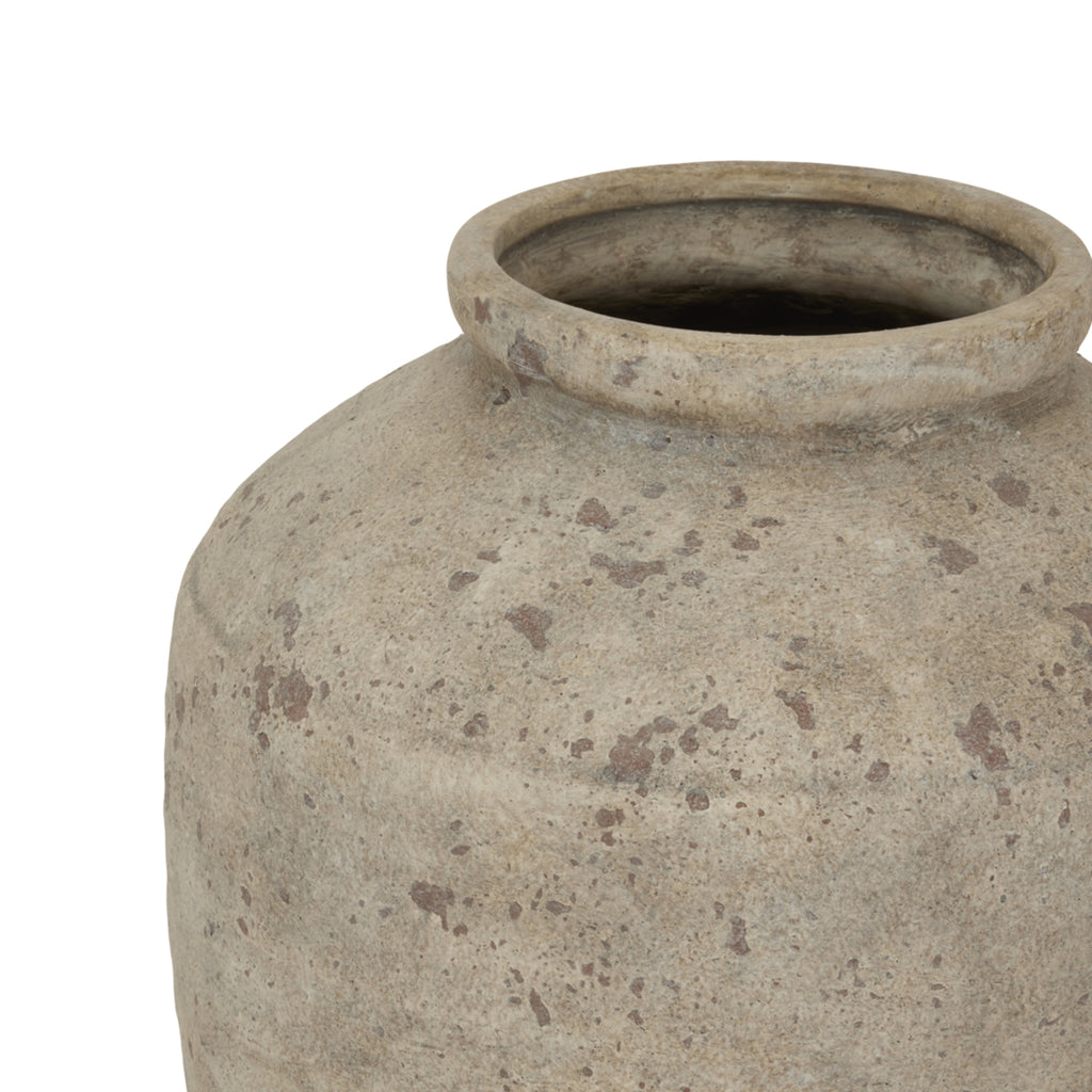 Terracotta pot with a textured surface on a white background