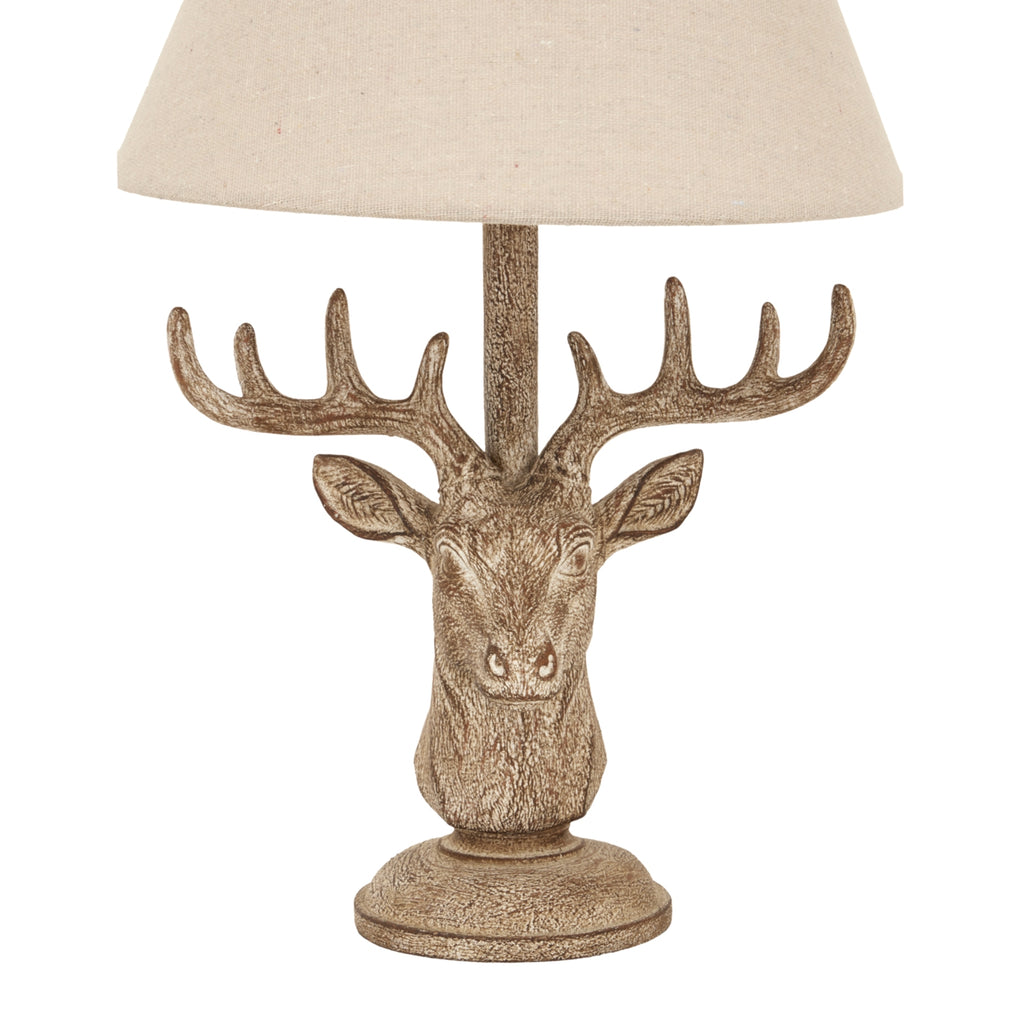 Decorative table lamp with a deer head design on a white background