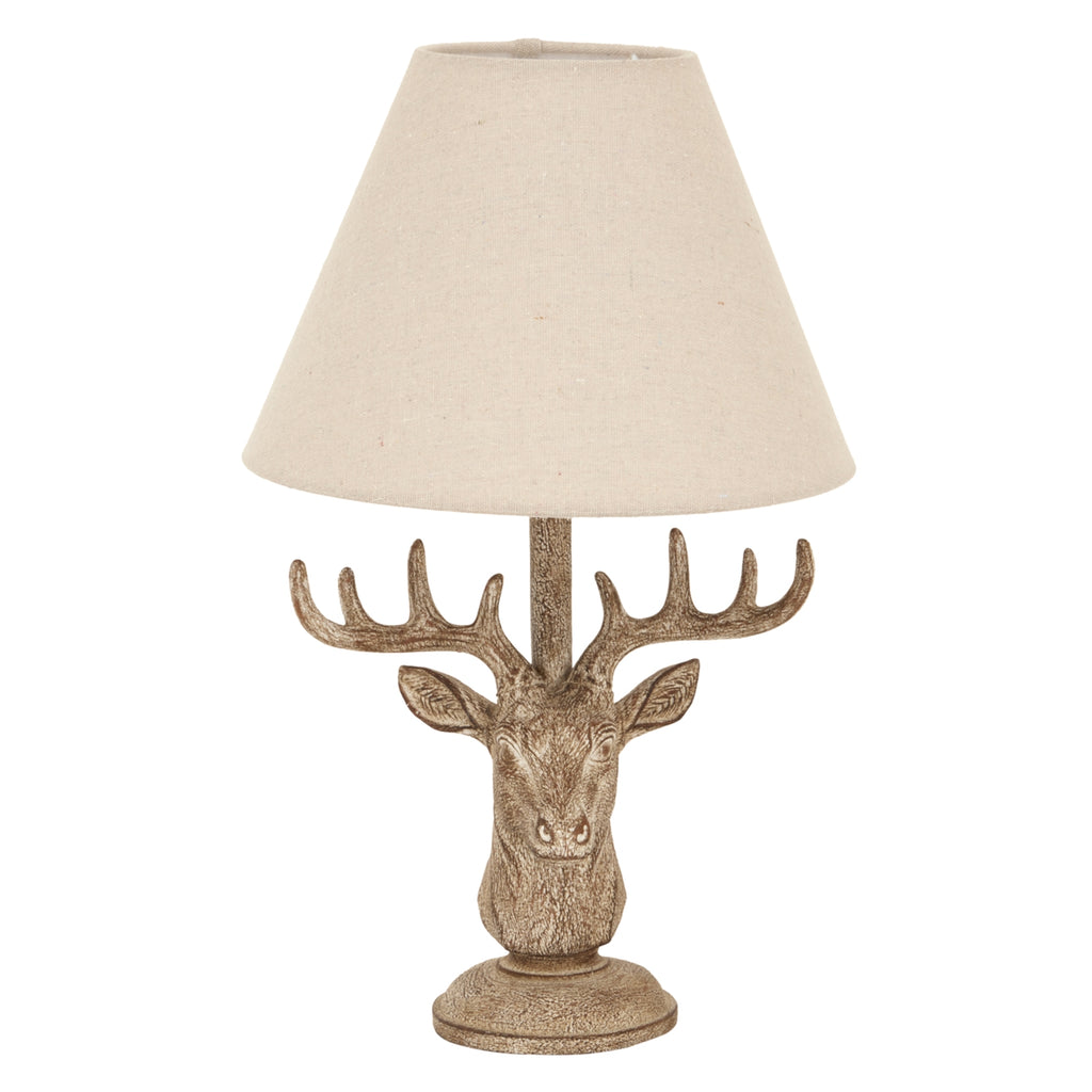 Decorative table lamp with deer head design and beige lampshade on a white background