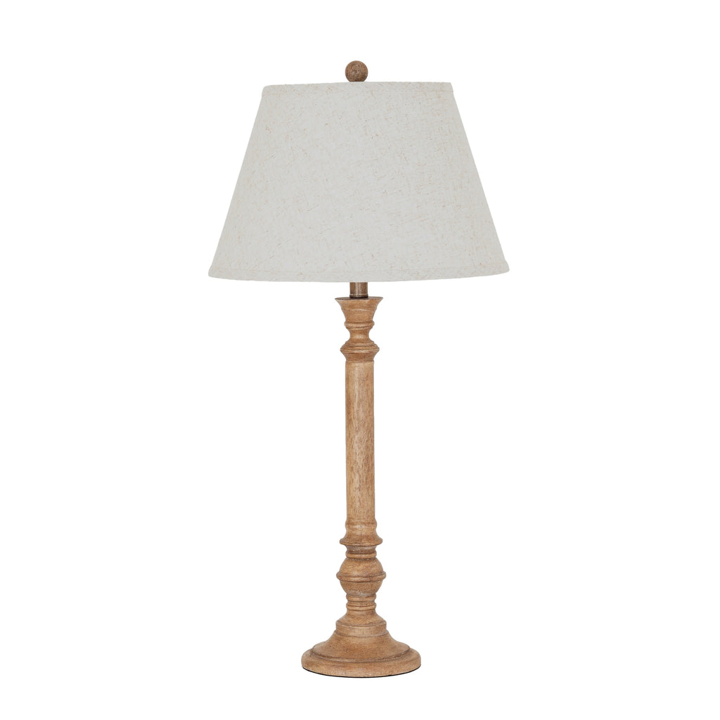 Table lamp with wooden base and white shade on a white background